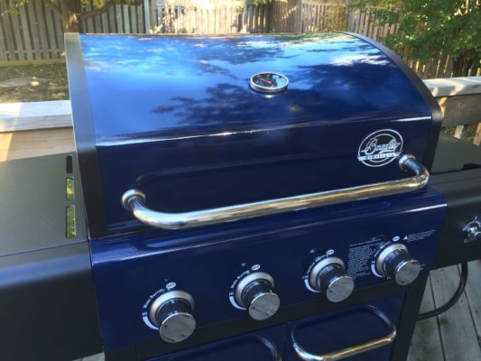 Blue grill on a backyard deck